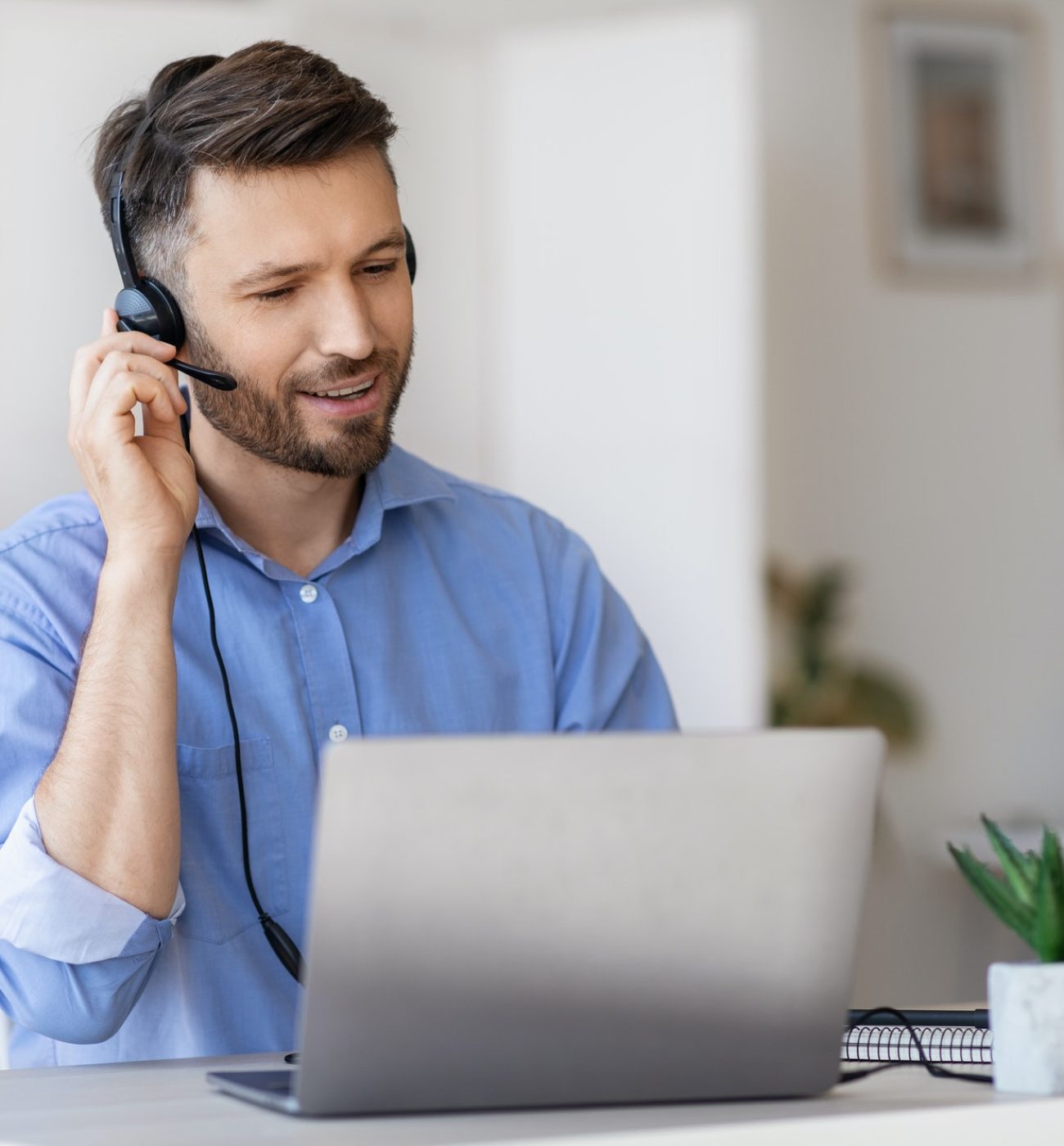 hotline-operator-portrait-of-call-center-employee-wearing-headset-at-workplace-in-office.jpg
